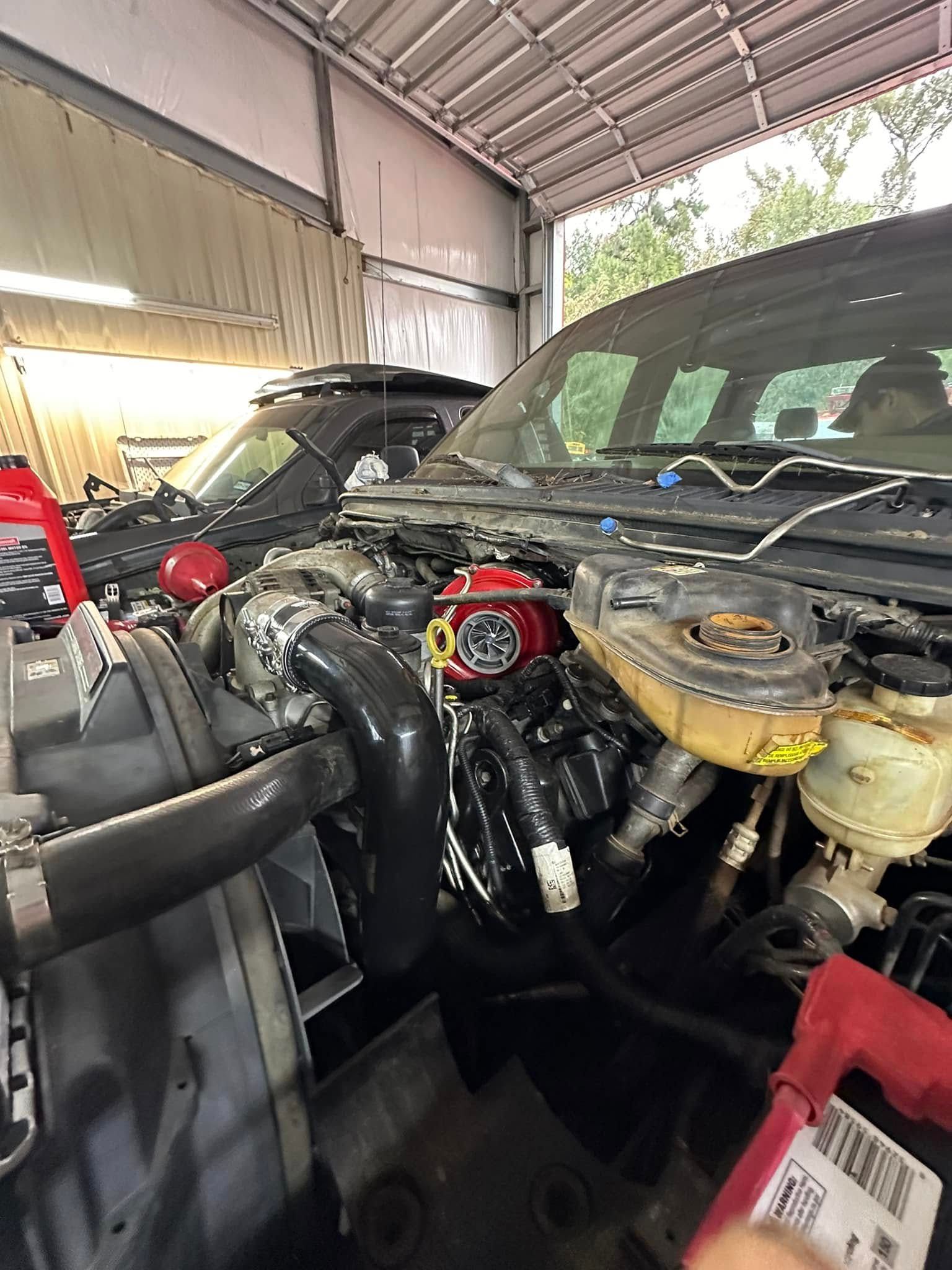 A car engine is being worked on in a garage.