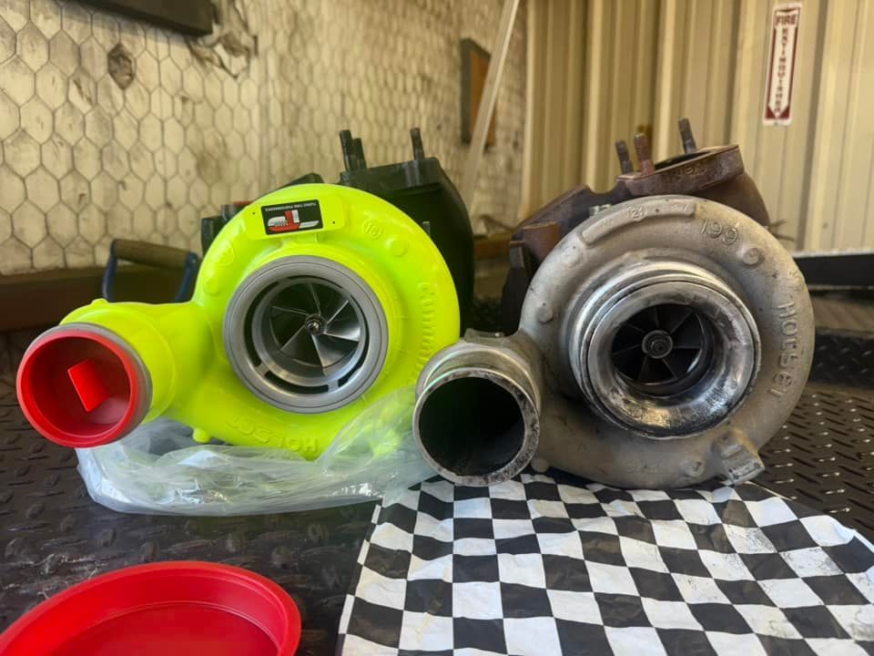 Two turbochargers are sitting on top of a checkered table cloth.