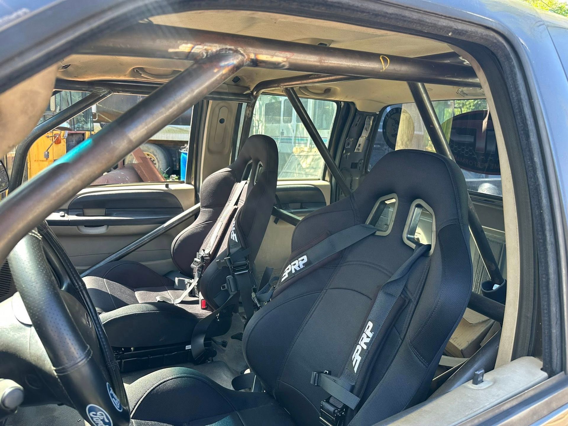 The inside of a race car with black seats