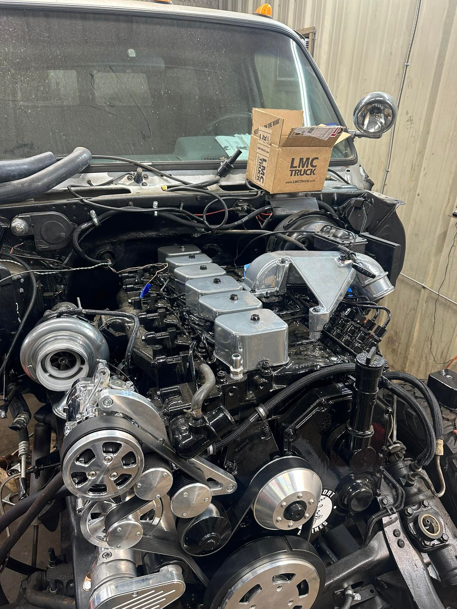 The engine of a truck is being worked on.