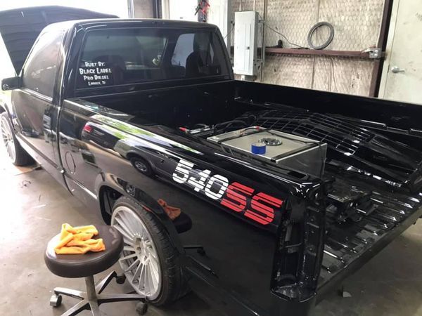 A black truck with the number 54055 on the back