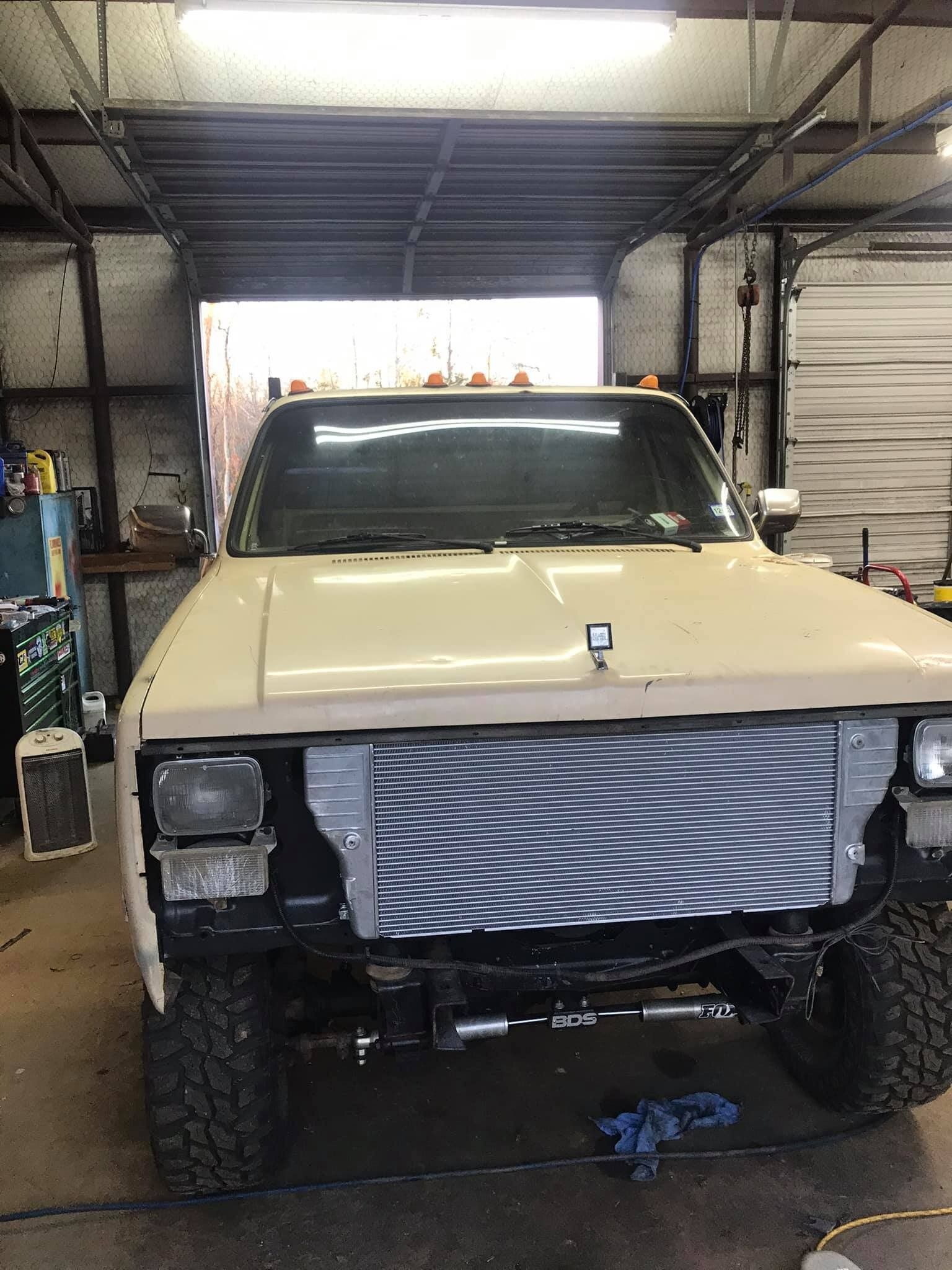 A truck is being worked on in a garage.