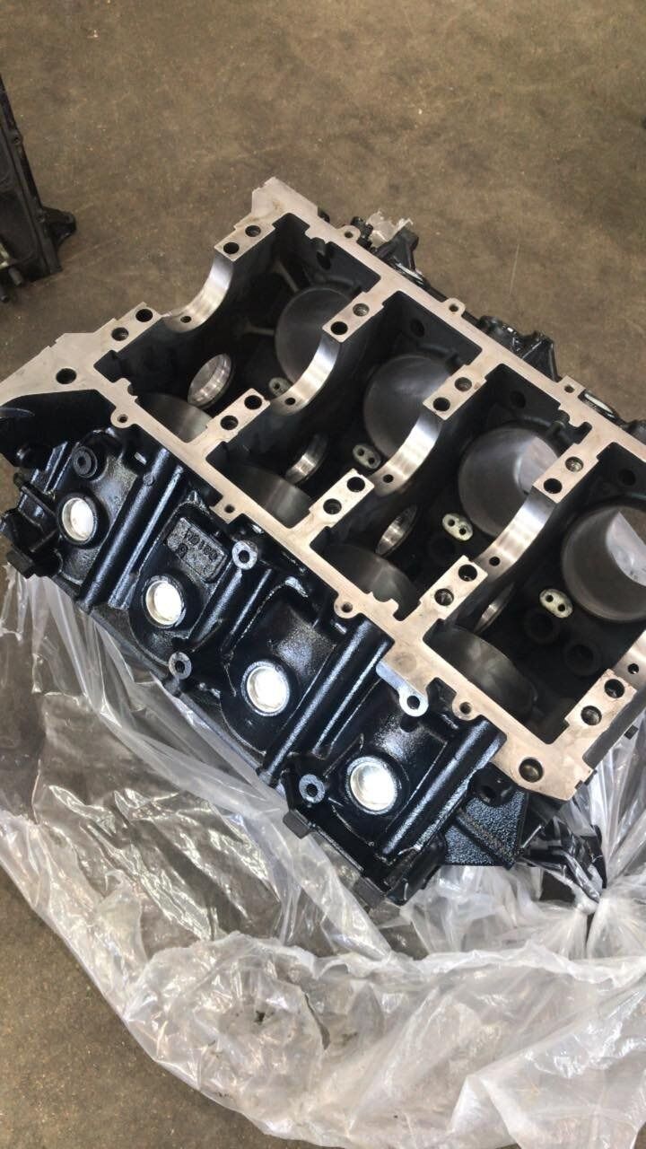 A block of a car engine is wrapped in plastic.