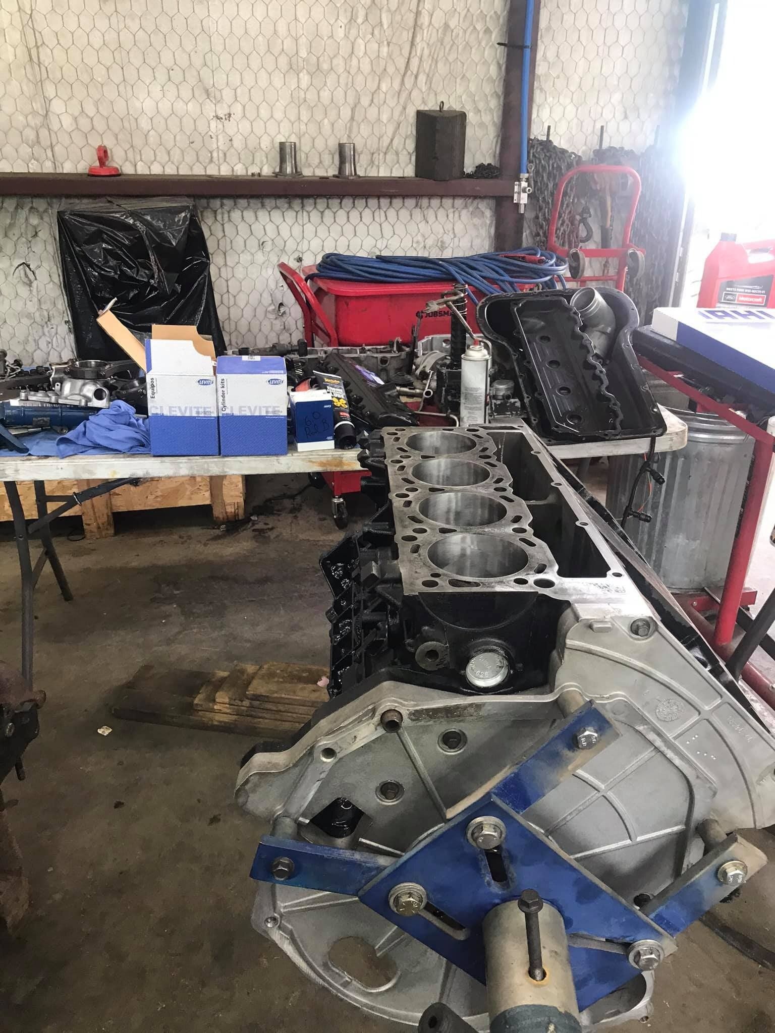 A car engine is being worked on in a garage.