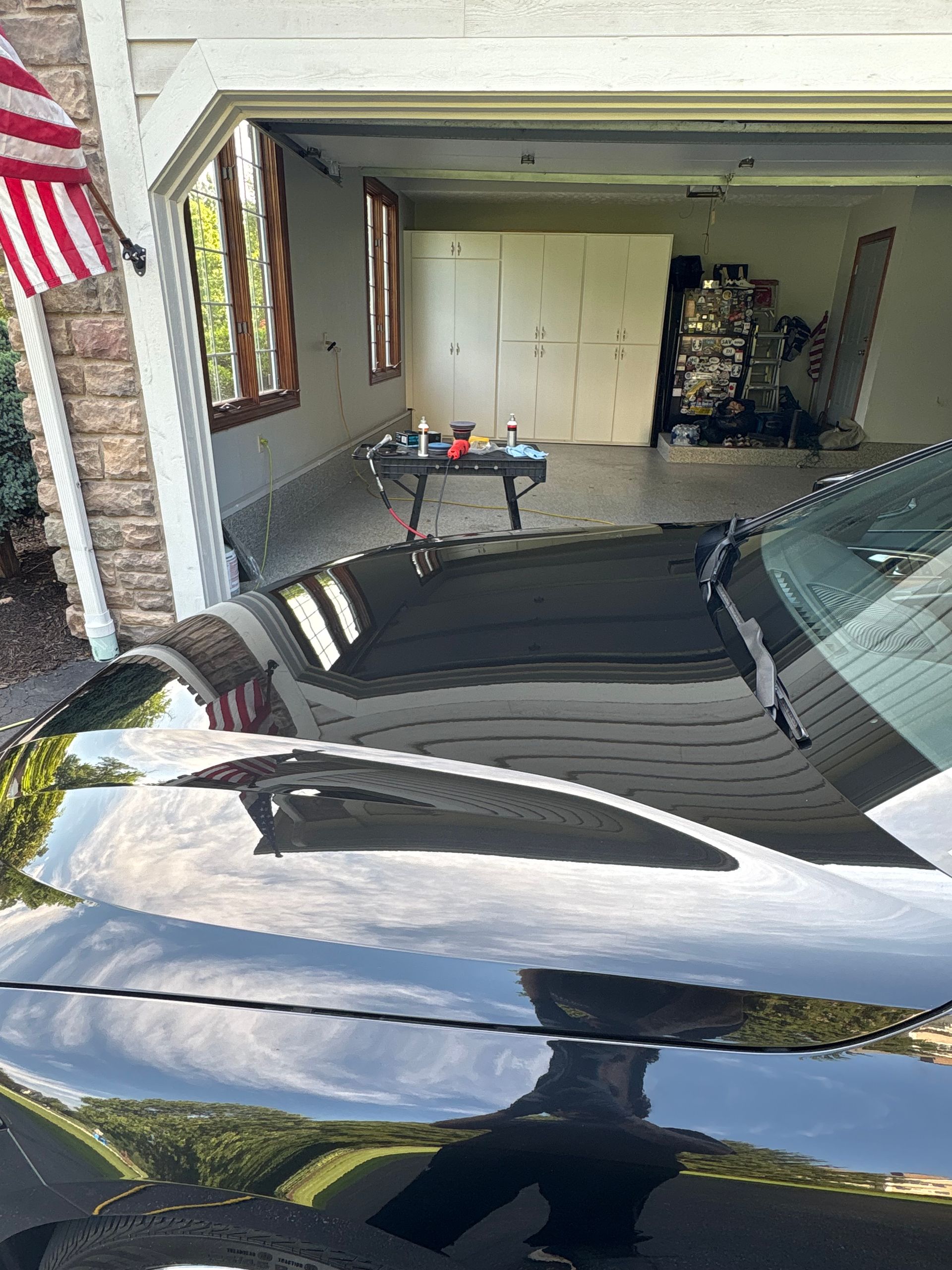 Black leather car seats, showing vertical stitched detailing. The setting is inside a vehicle.