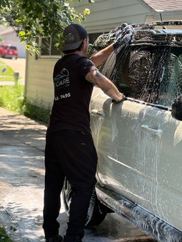 Matte gray Audi RS 6 parked outside; features black wheels, red brake calipers, and a black honeycomb grille.