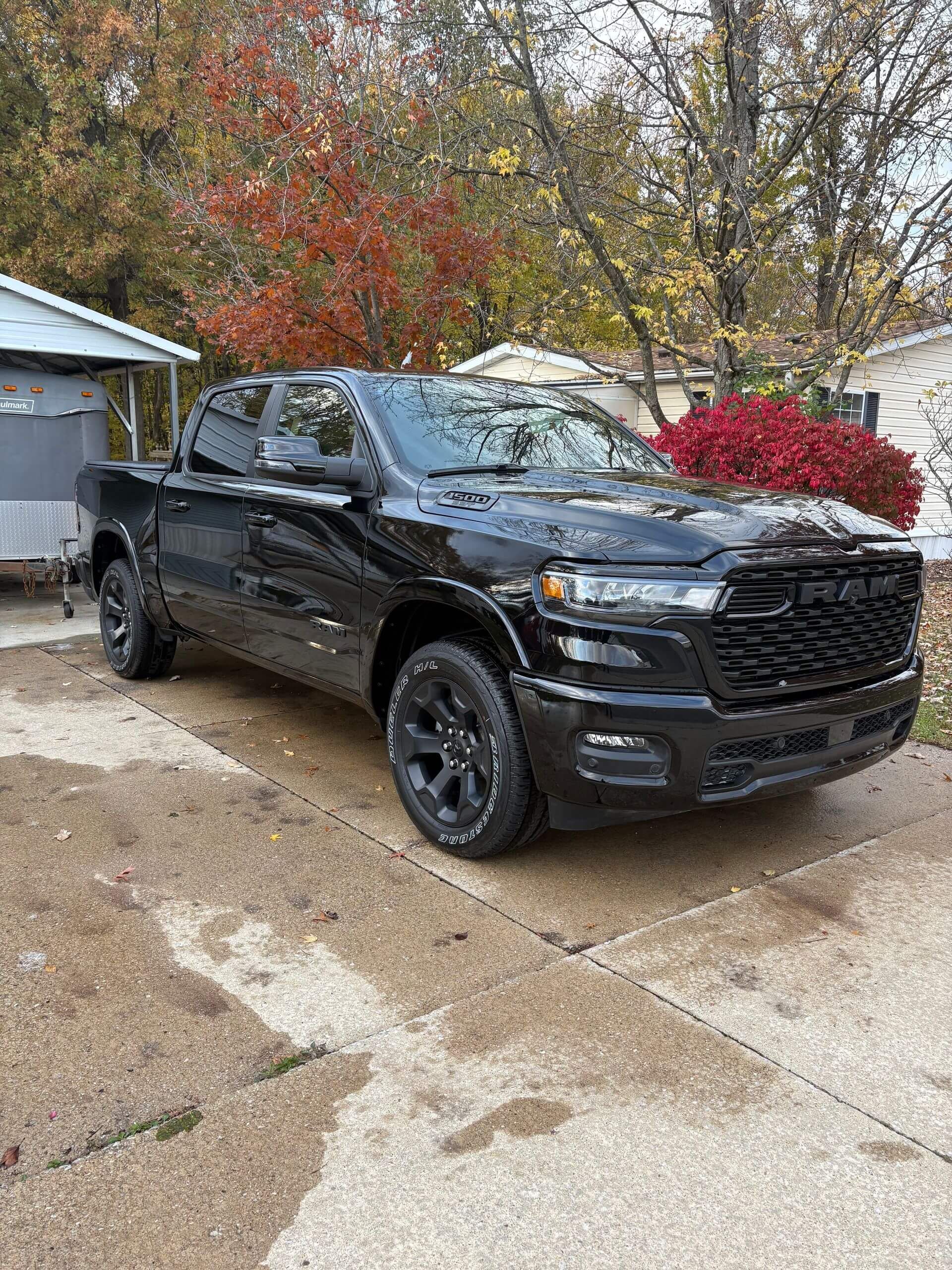 Black Ram truck parked outside on concrete.