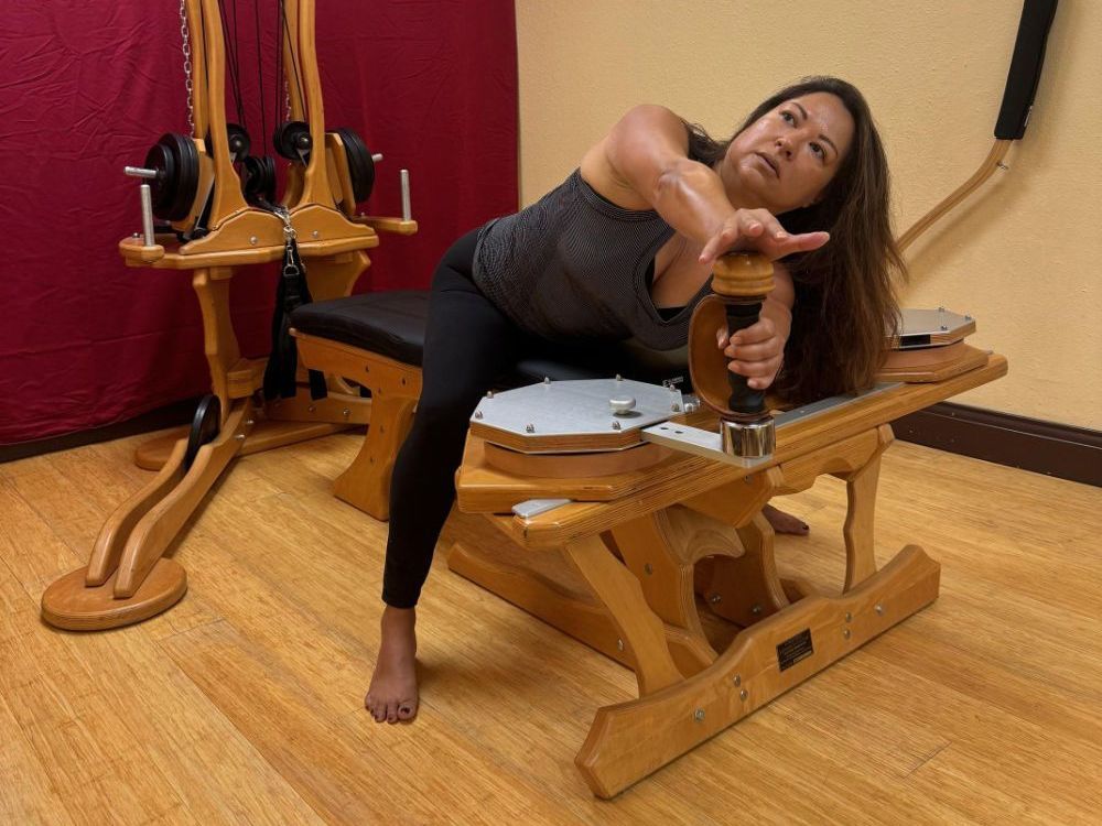 women stretching on a gyrotonic machine