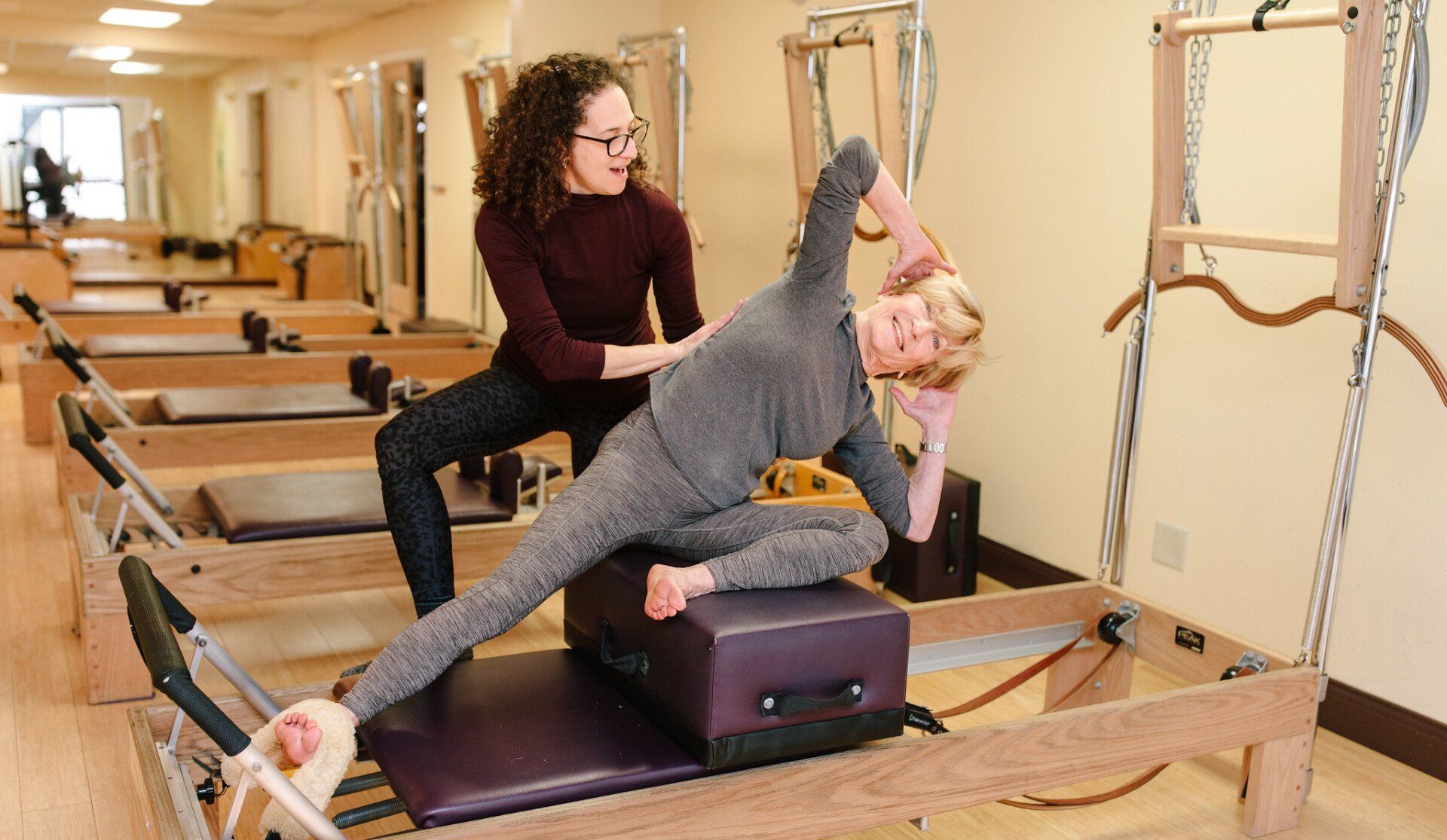 Pilates studio with people stretching