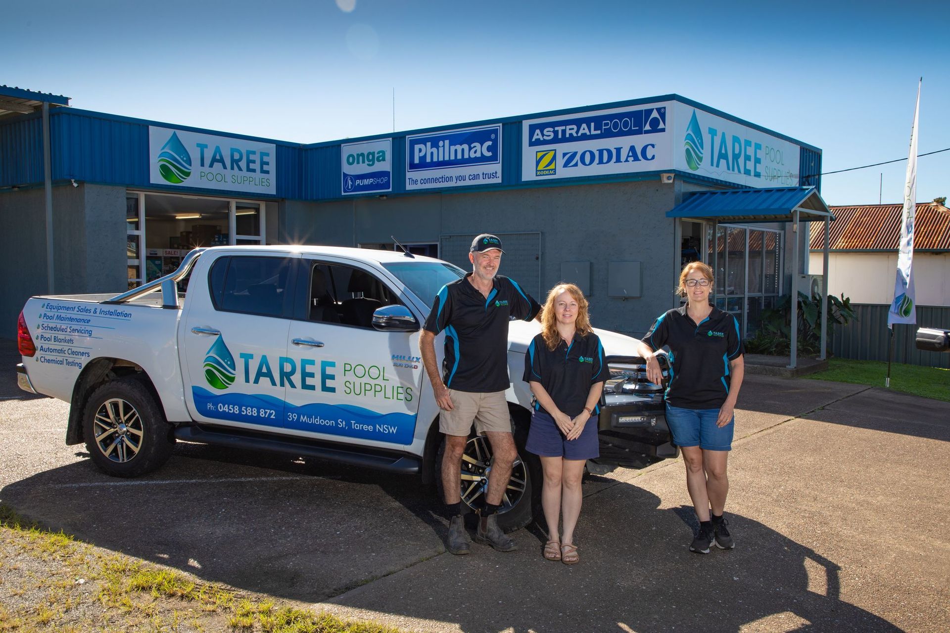 Taree Vehicle Parked Outside a Taree Building, with Three People Standing in Front — Taree Water Works in Taree, NSW
