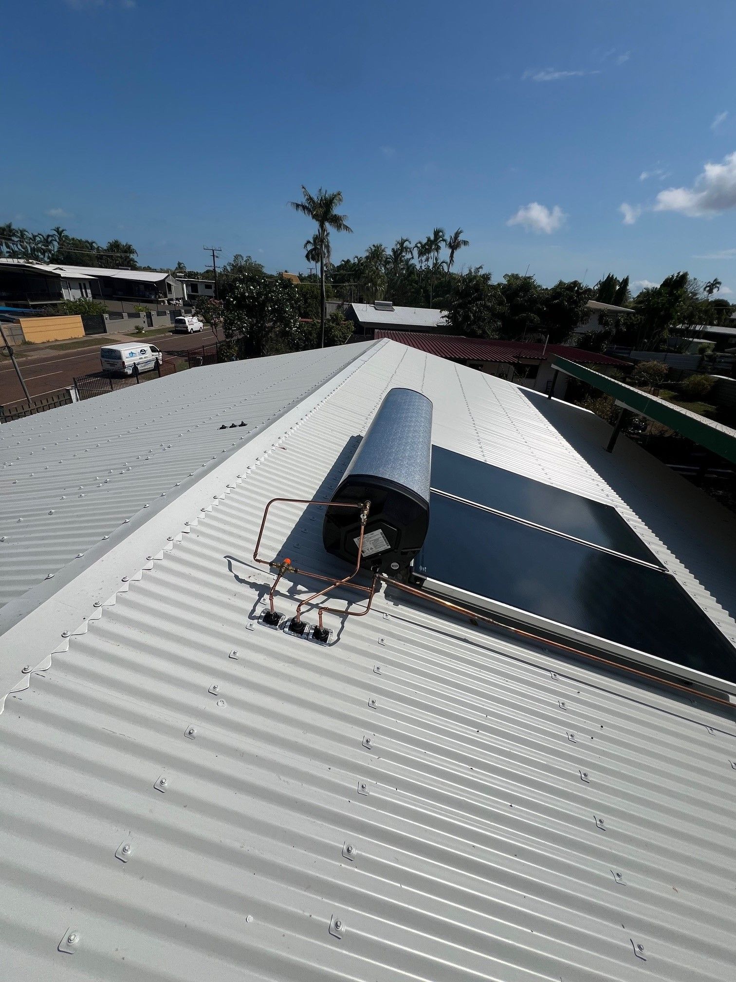 A man is standing on a ladder working on a chimney.