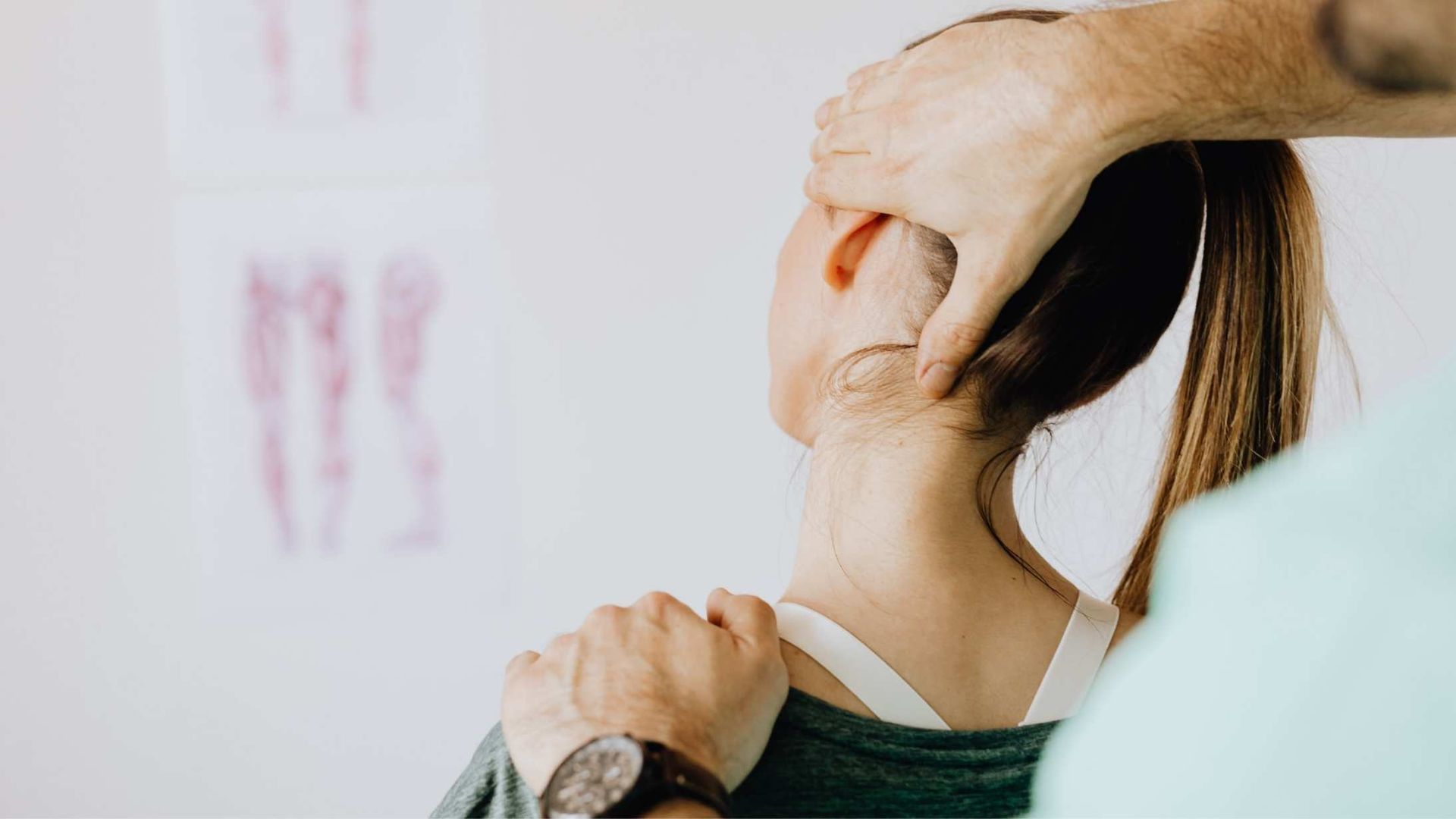 Chiropractor adjusting a person's neck. Hands on neck and shoulder. White background.