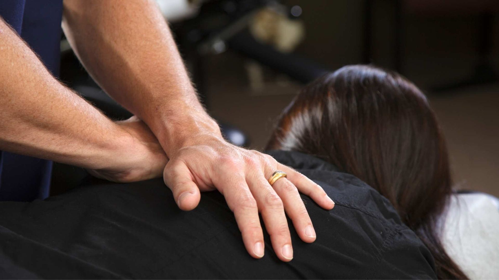 Hands on a person's back; a chiropractic adjustment.