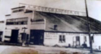 A black and white photo of a building with a large dome roof