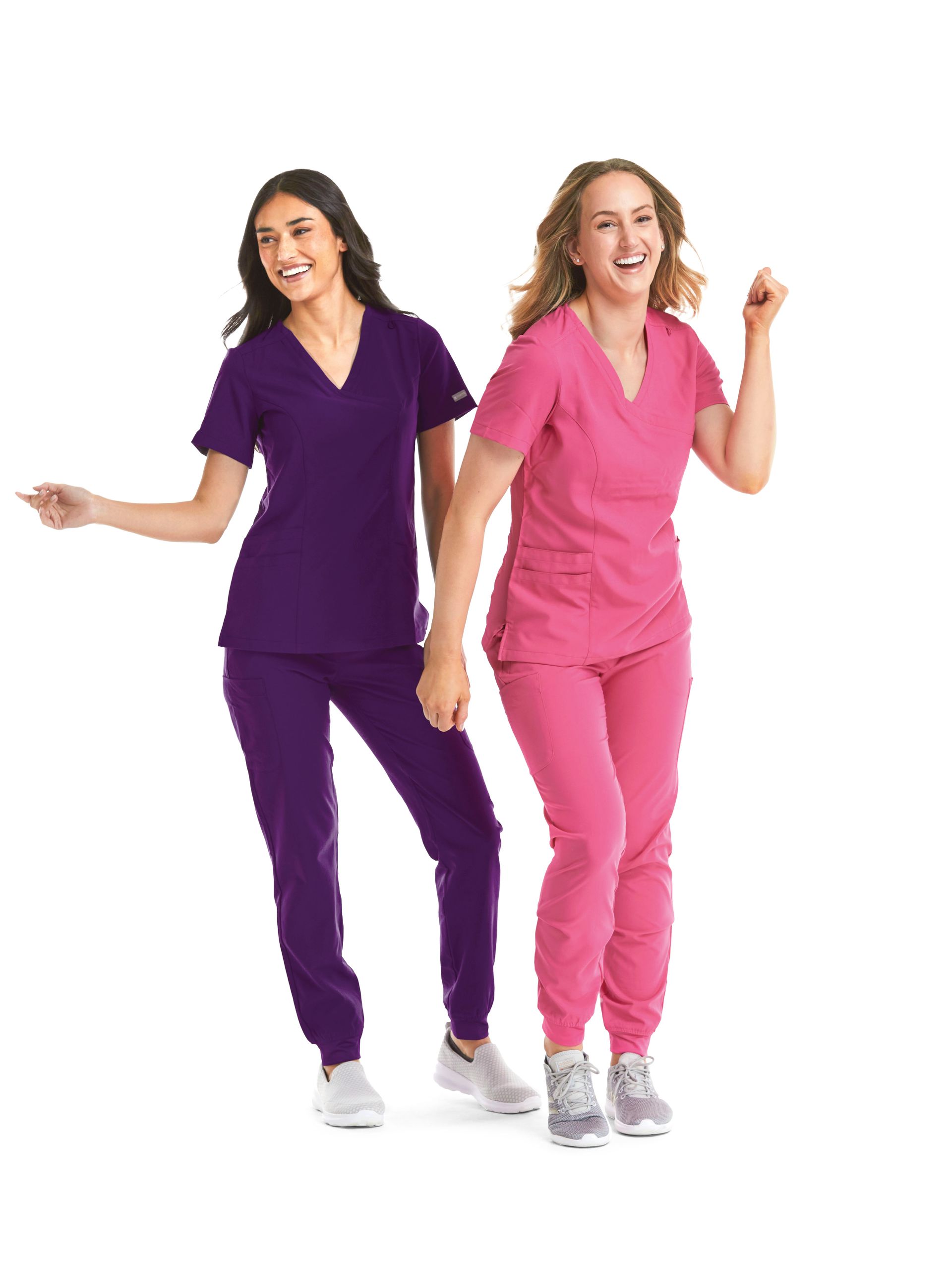 Two women are standing next to each other wearing scrubs.