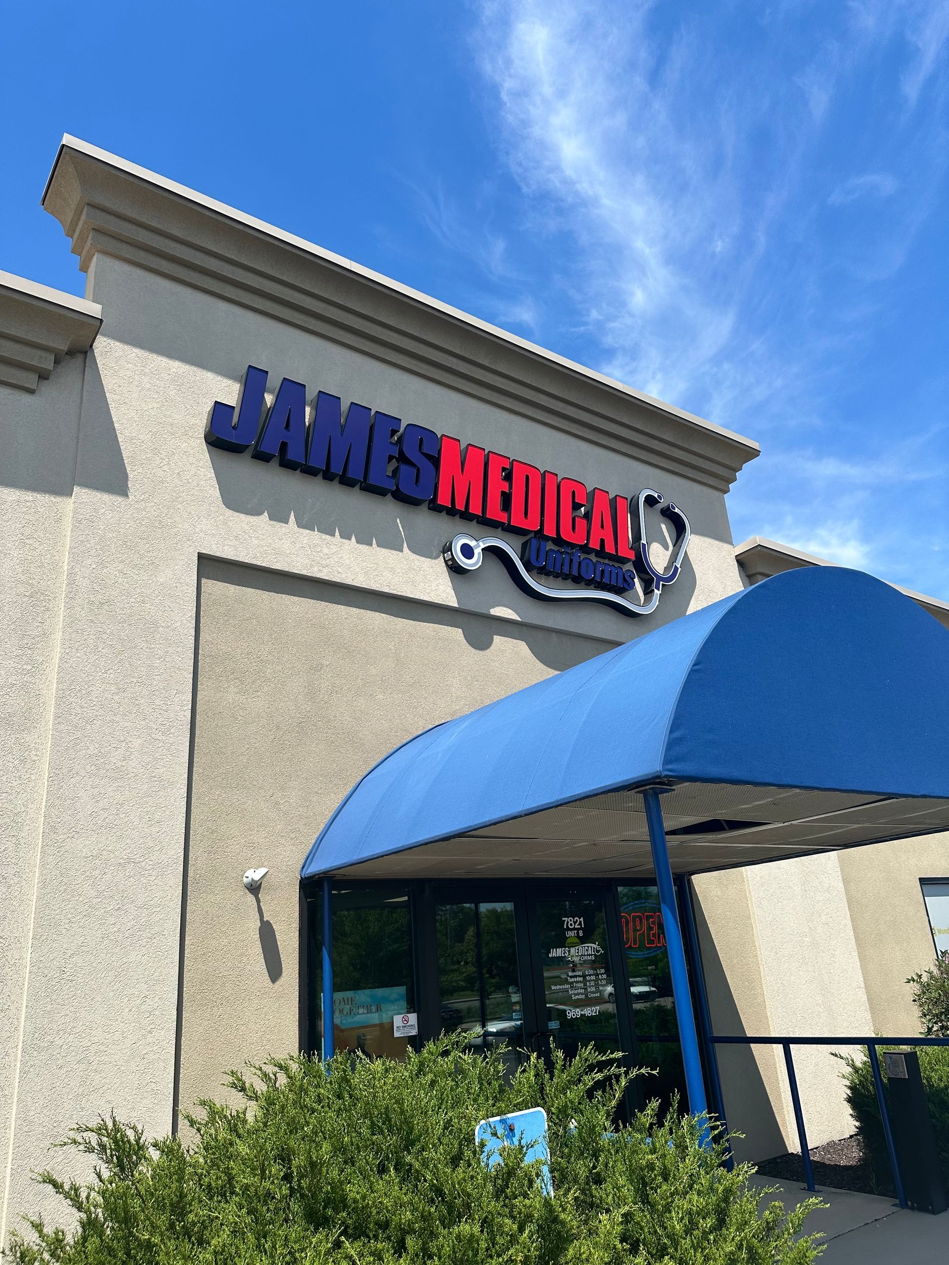The front of james medical uniforms with a blue awning