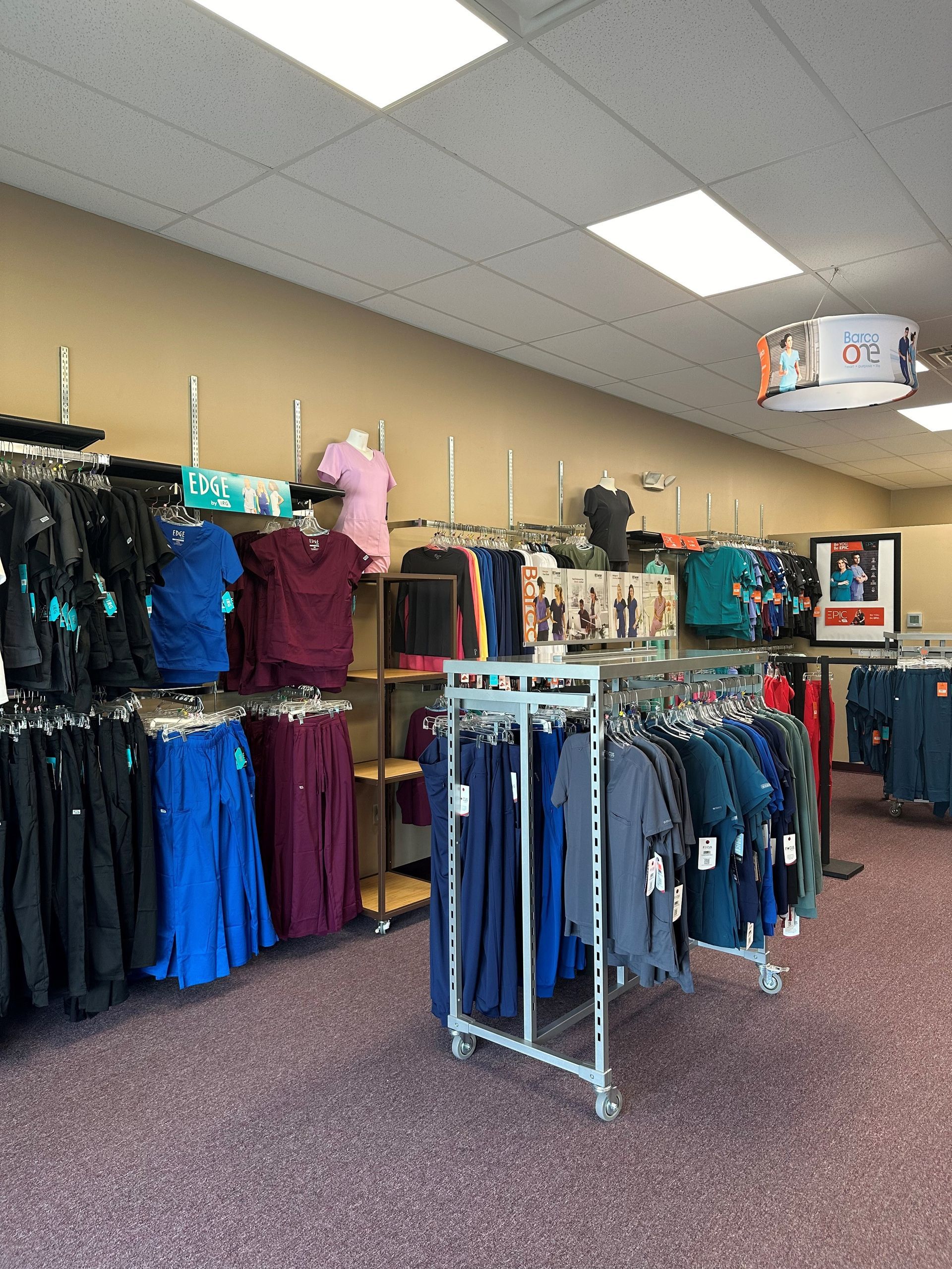 A store filled with lots of clothes including scrubs