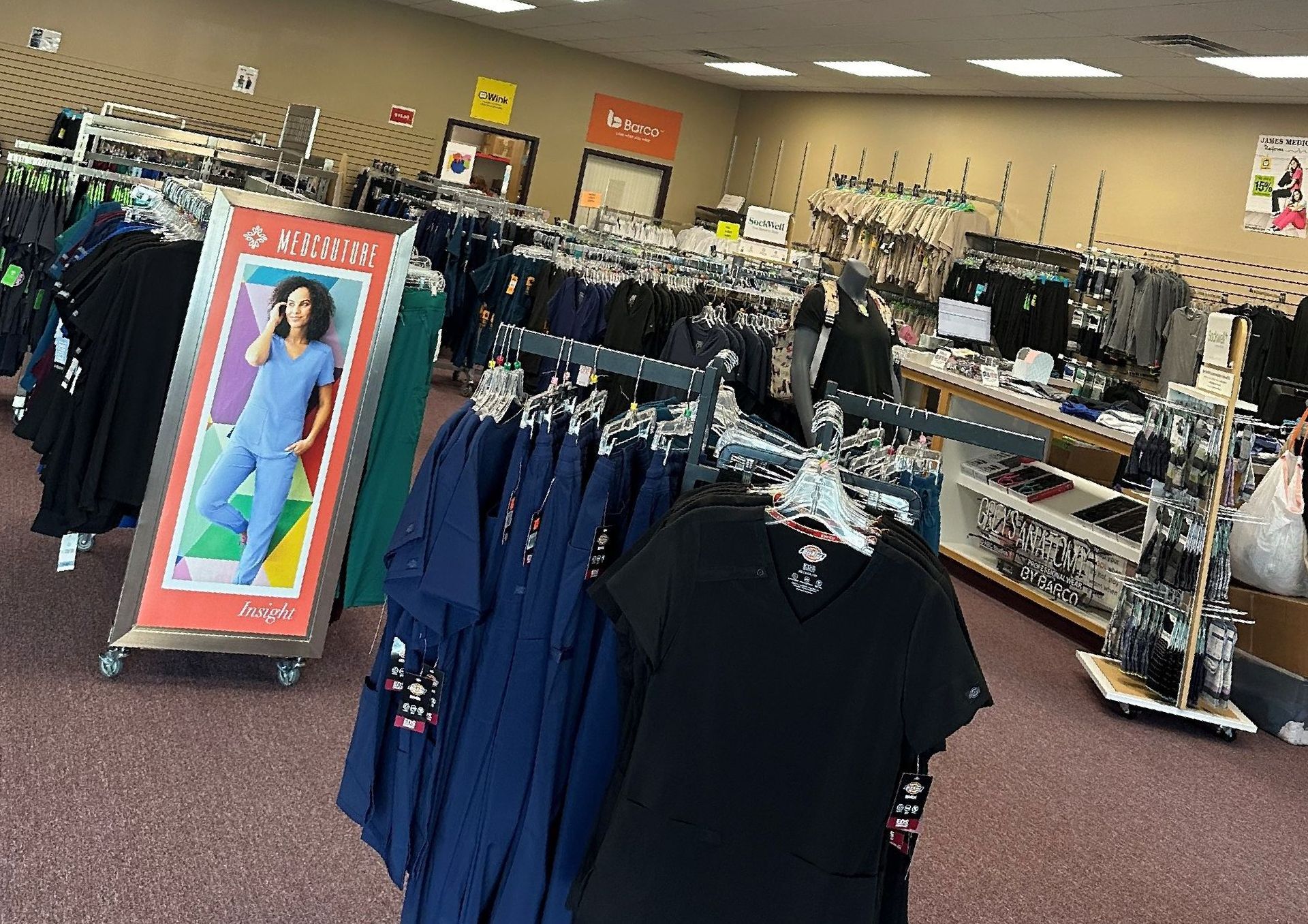 A store filled with lots of scrubs and shirts.
