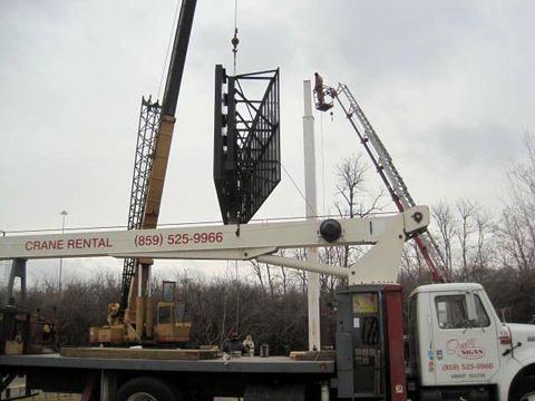 crane lifting the signboard