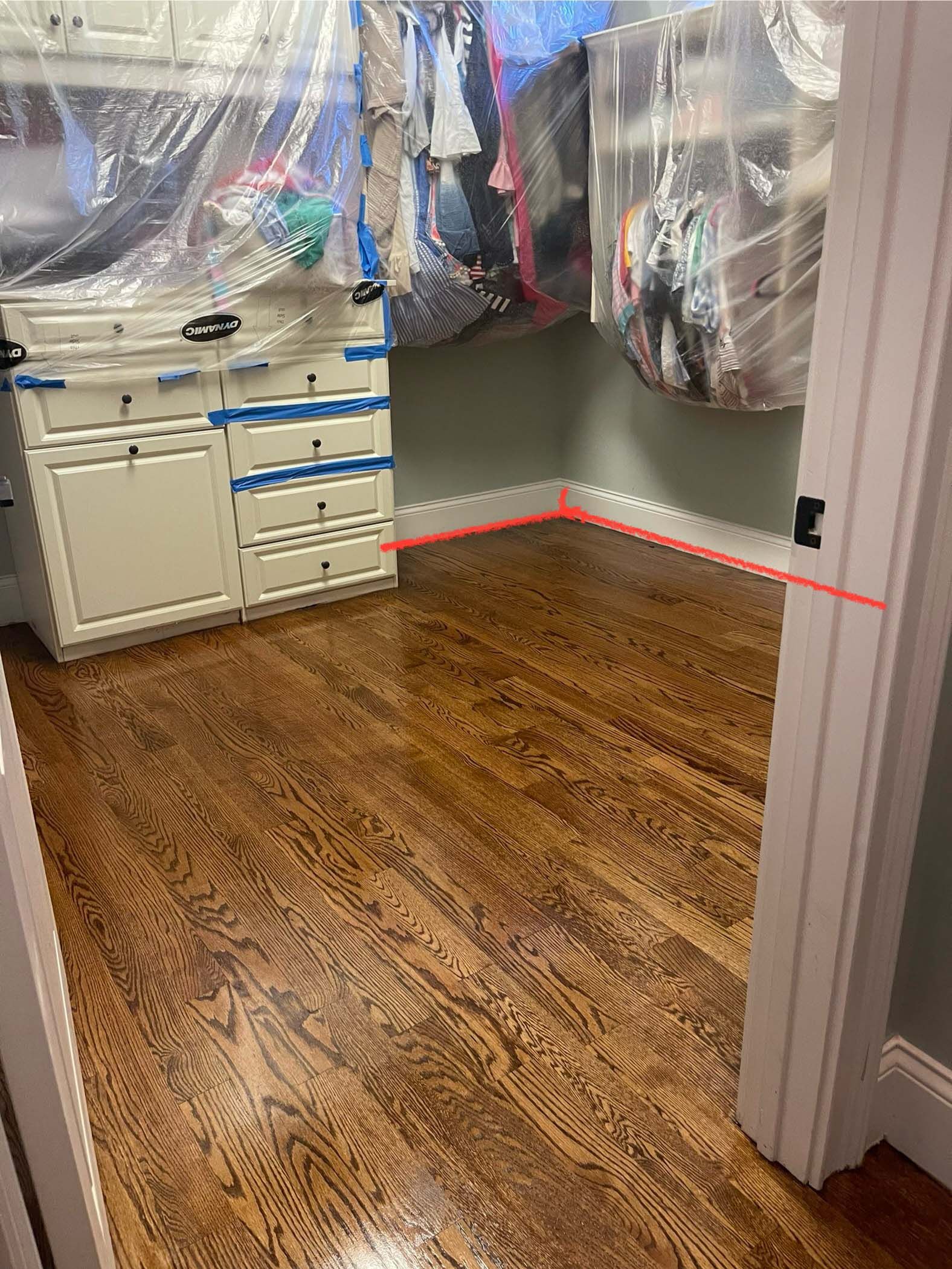 Wooden floor and a built-in cabinet. A room corner is outlined with red lines.