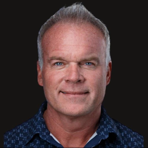 A man and a woman are sitting on a dock overlooking a lake.