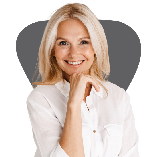 A woman in a white shirt is smiling with her hand on her chin.