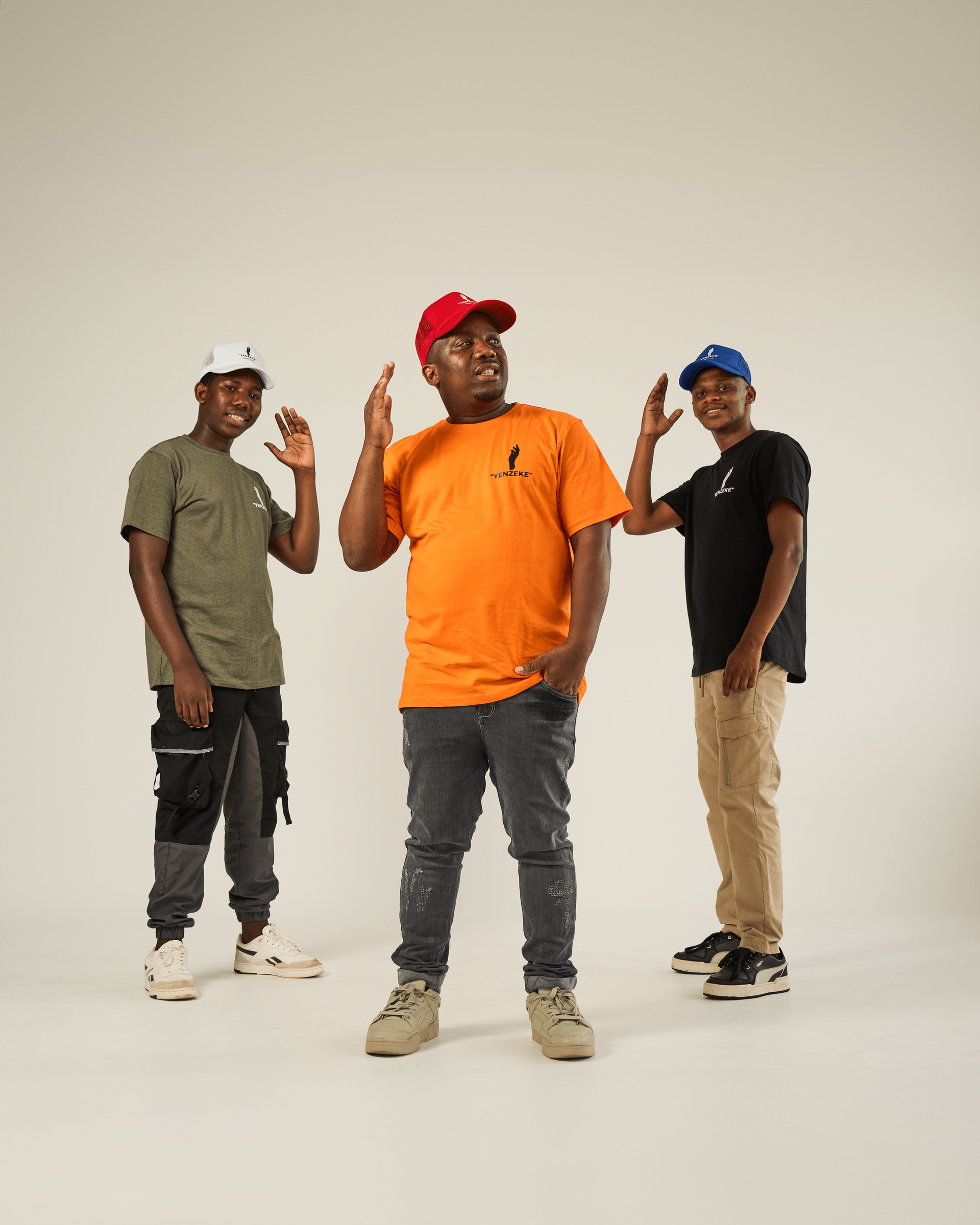 Three men are standing next to each other on a white background.