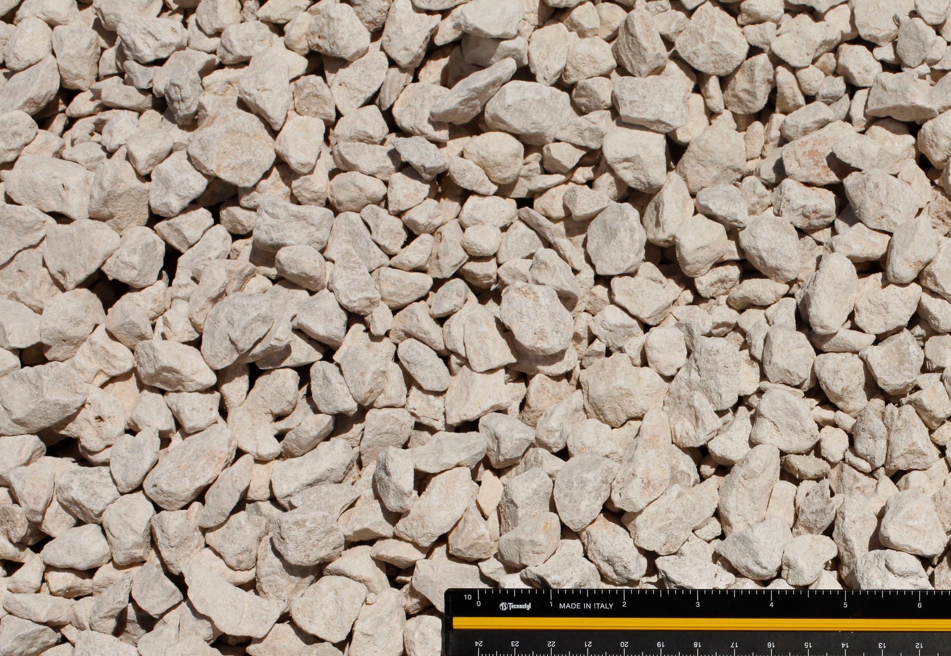 A ruler is laying on top of a pile of rocks