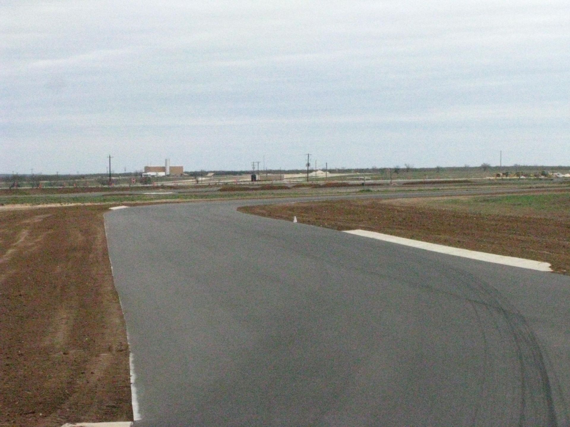 A road with a lot of dirt on the side of it