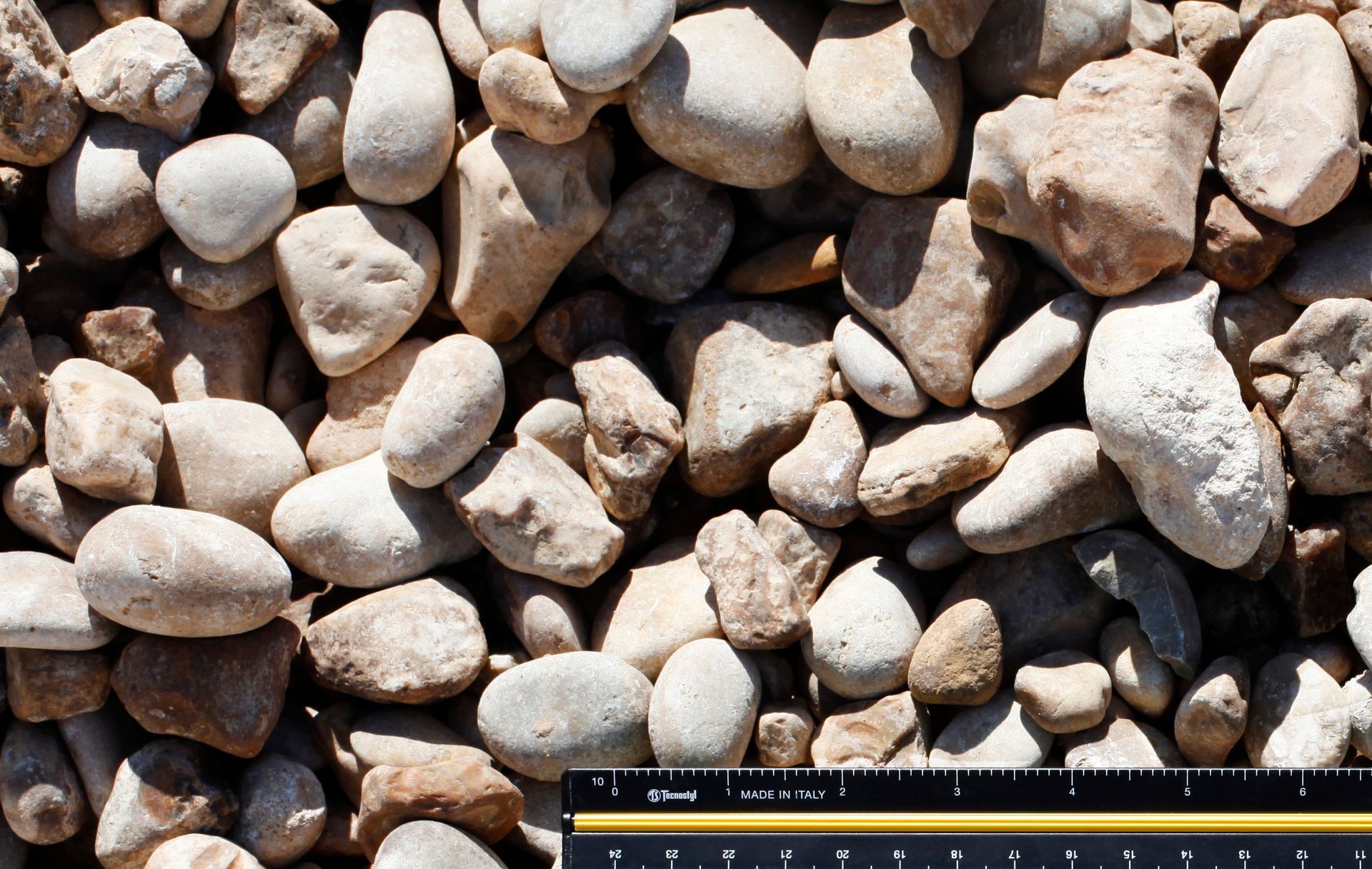 A ruler is next to a pile of rocks.