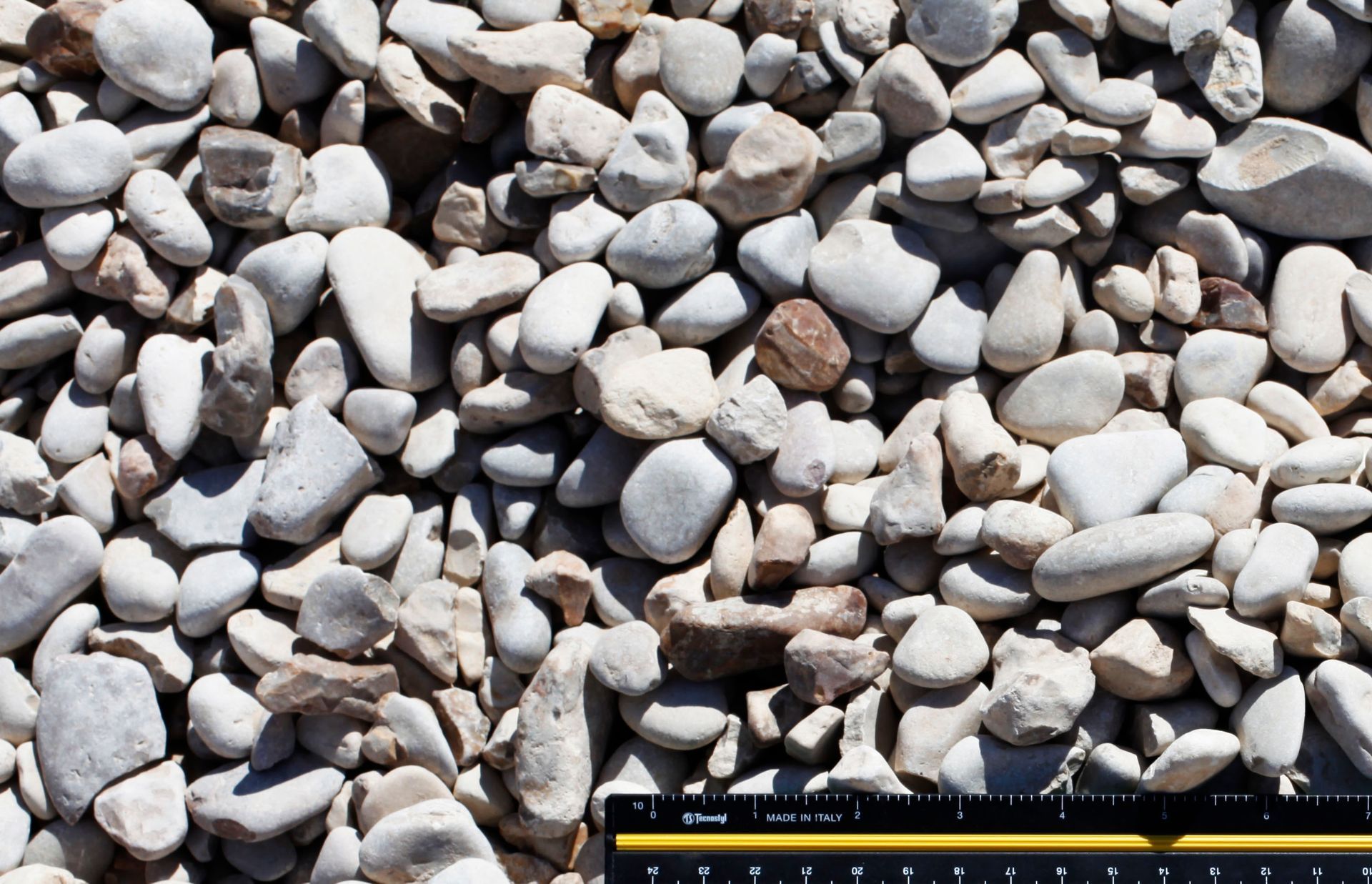 A ruler is sitting on top of a pile of rocks.