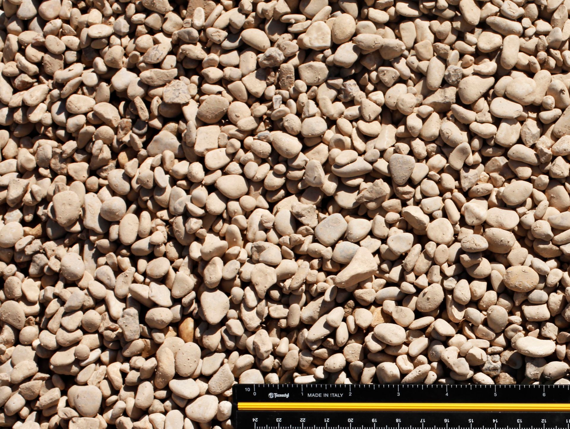 A pile of rocks next to a ruler.