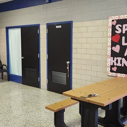 A room with a table and benches and a sign that says i love you