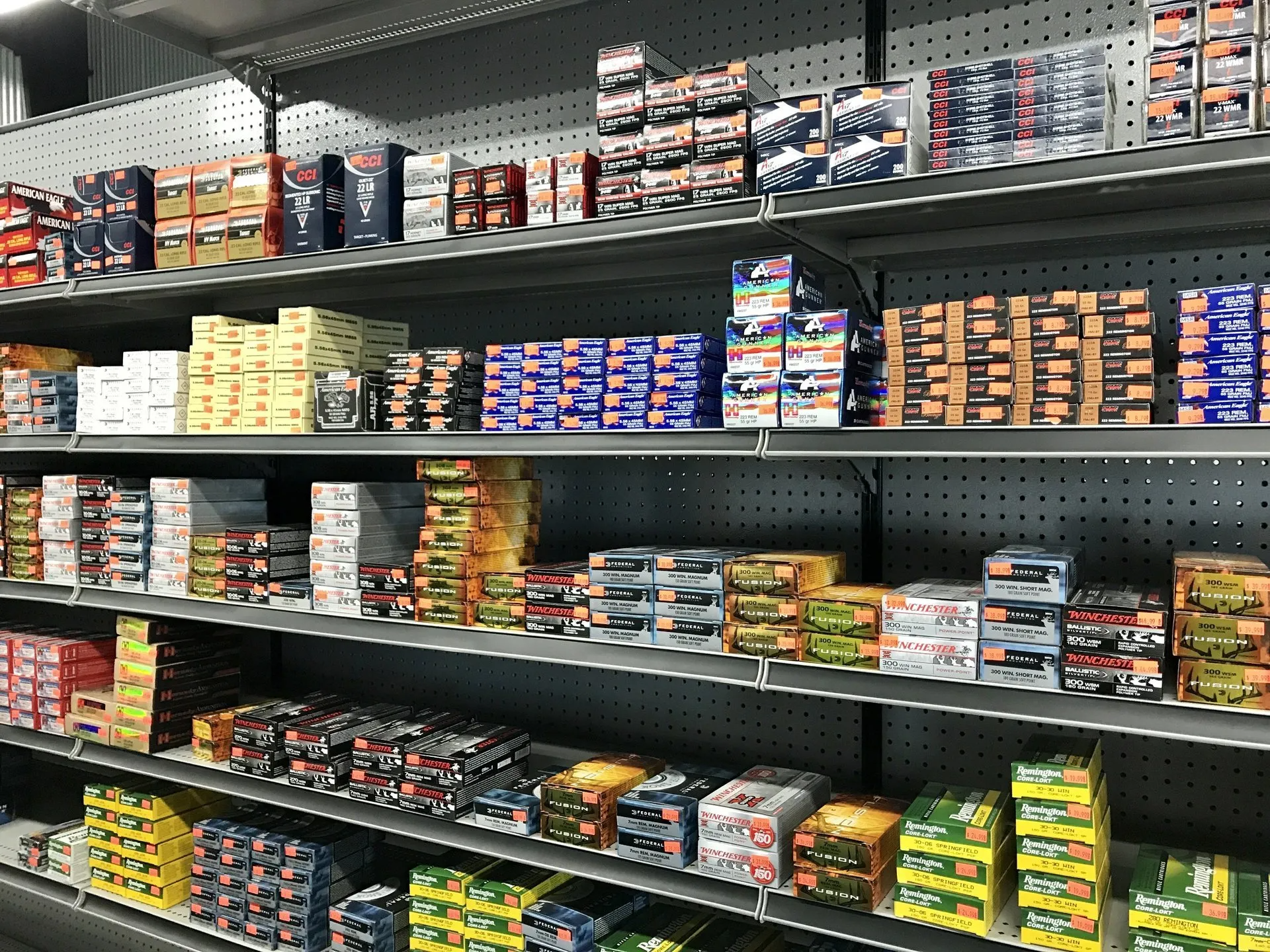 Shelves stocked with various boxes and containers, likely automotive parts, in a store setting.