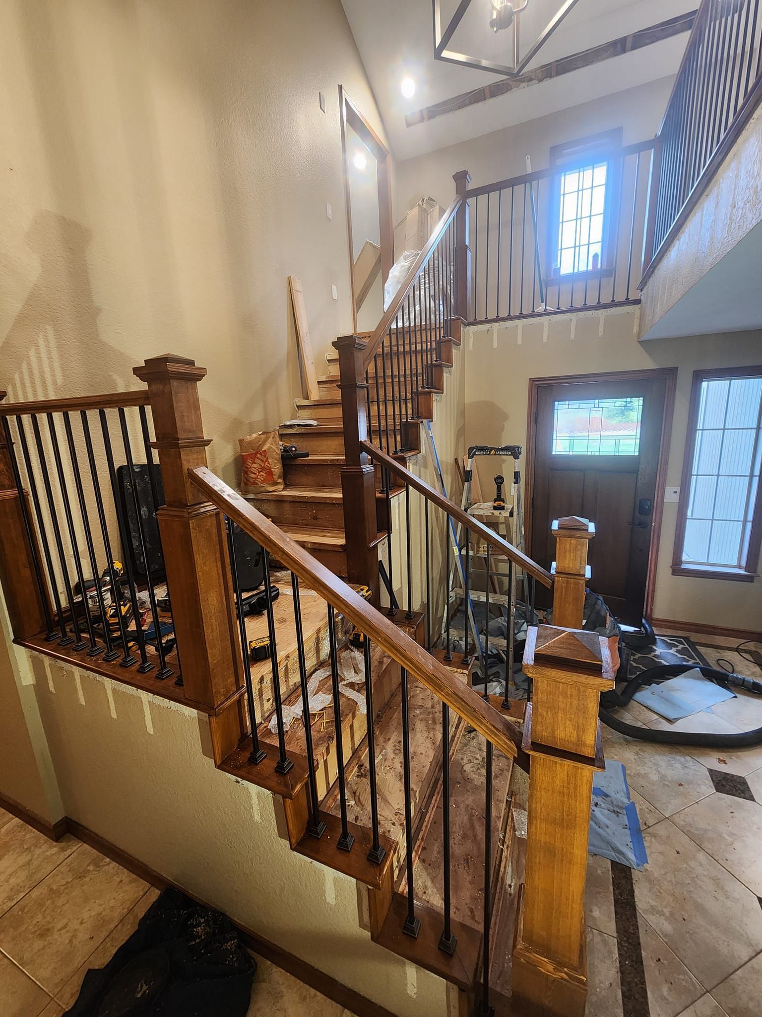 Wooden staircase with black metal balusters; interior.