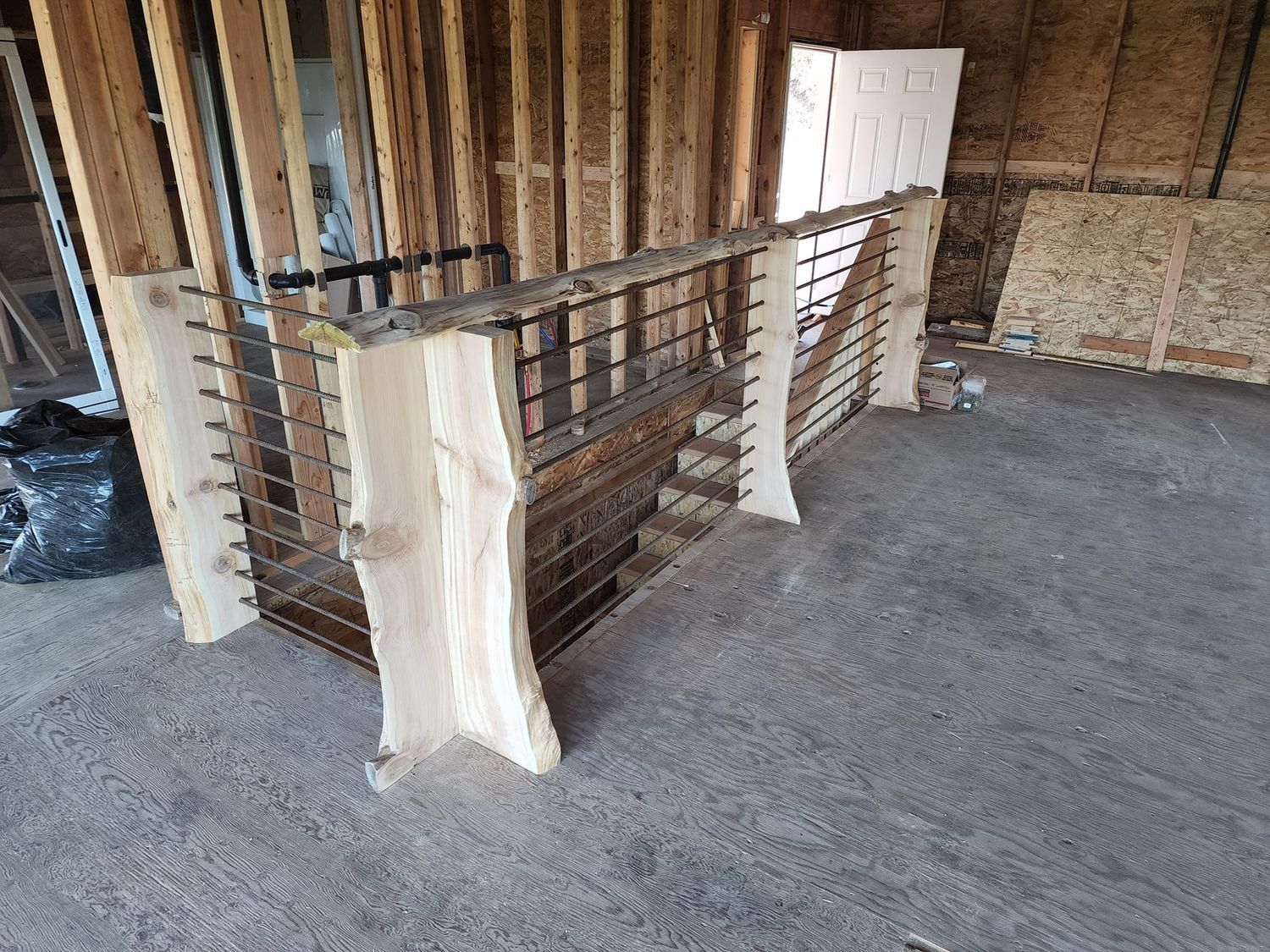 Wooden bar with metal grid, set against a wood frame in a dusty room.