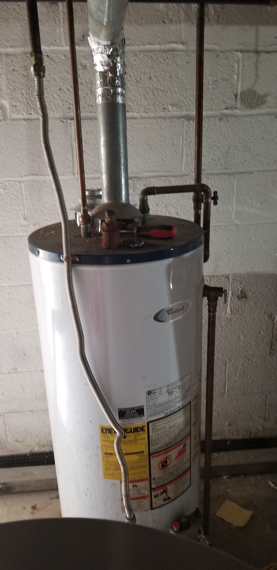 Older tank-style water heater evaluated by licensed plumber in Central Connecticut
