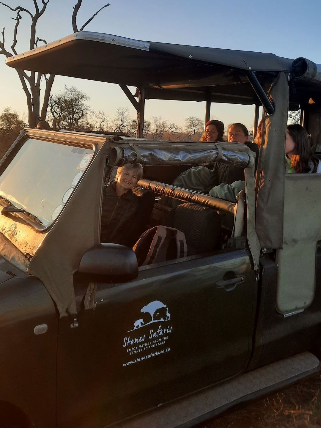 A group of people are sitting in a jeep.