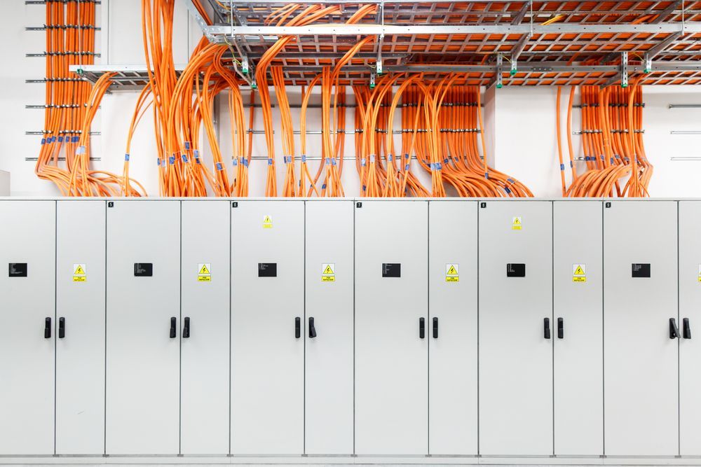 A Bunch of Orange Wires Hanging From the Ceiling — Advantage Communications & Electrical in Maroochydore, QLD