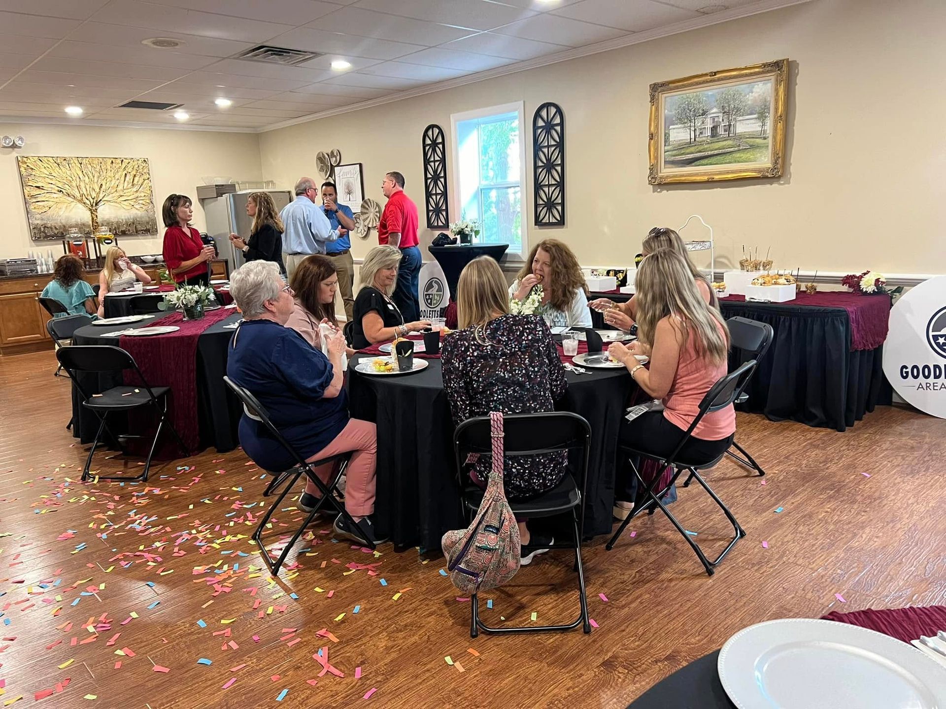 A group of people are sitting at tables in a room.