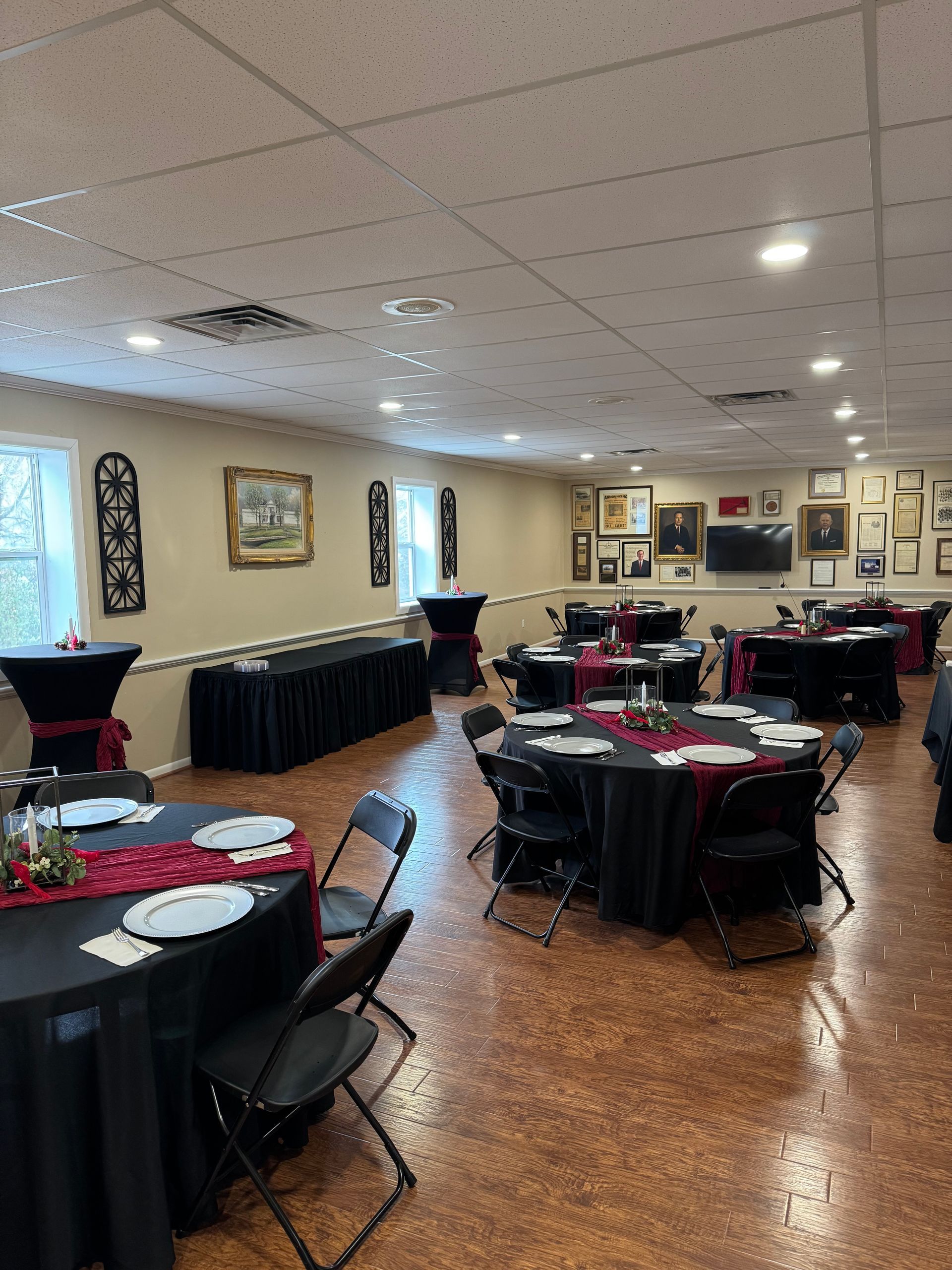 A large room with tables and chairs set up for a party.