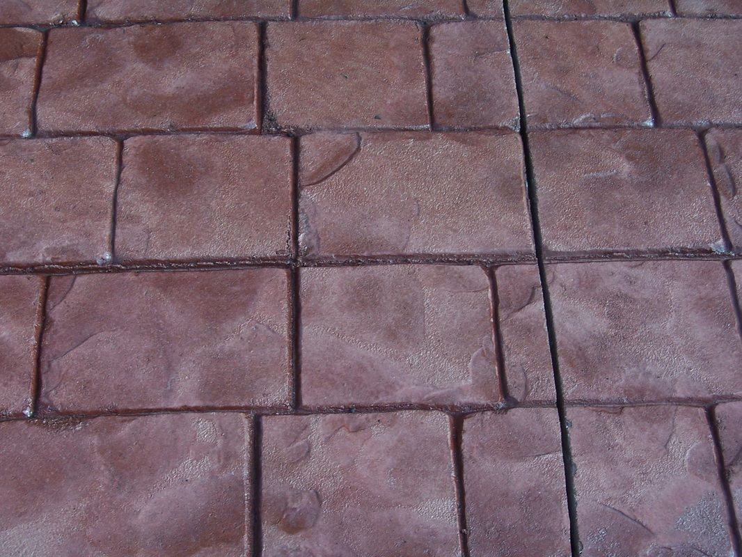 A close up of a brick floor with a grid pattern