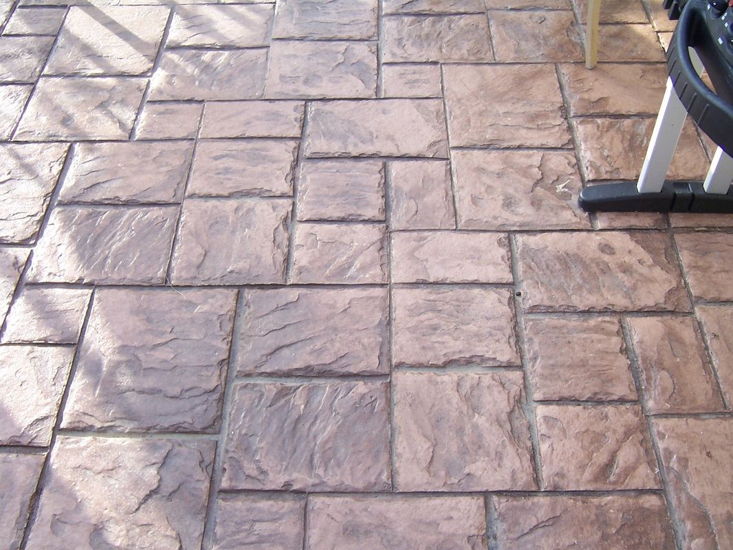 A brick floor with a chair in the background