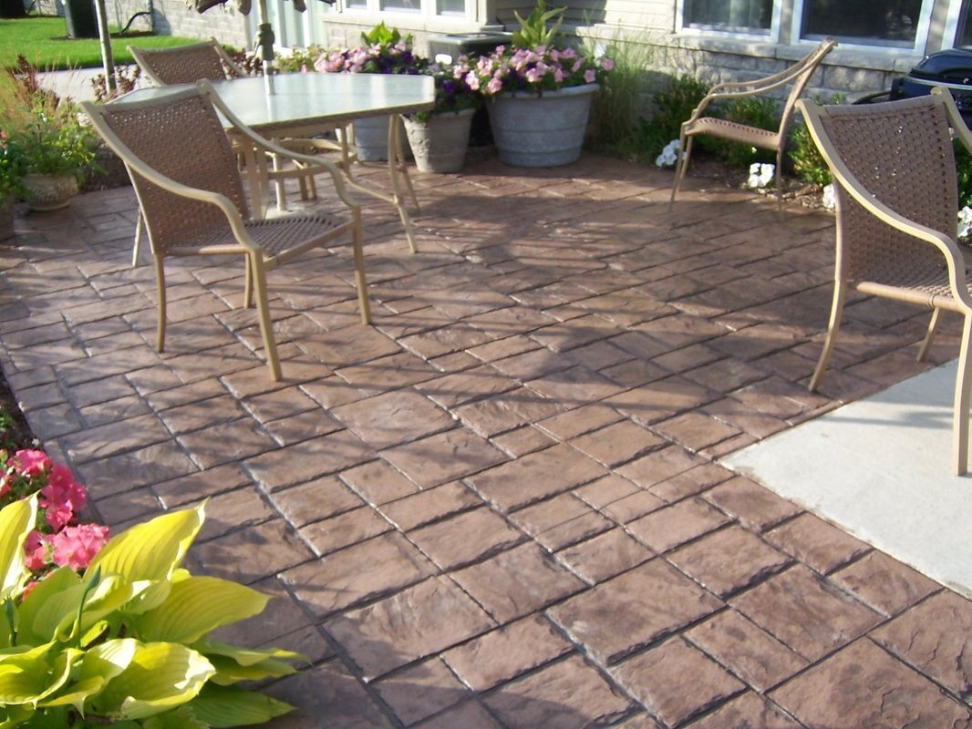 A patio with a table and chairs on it
