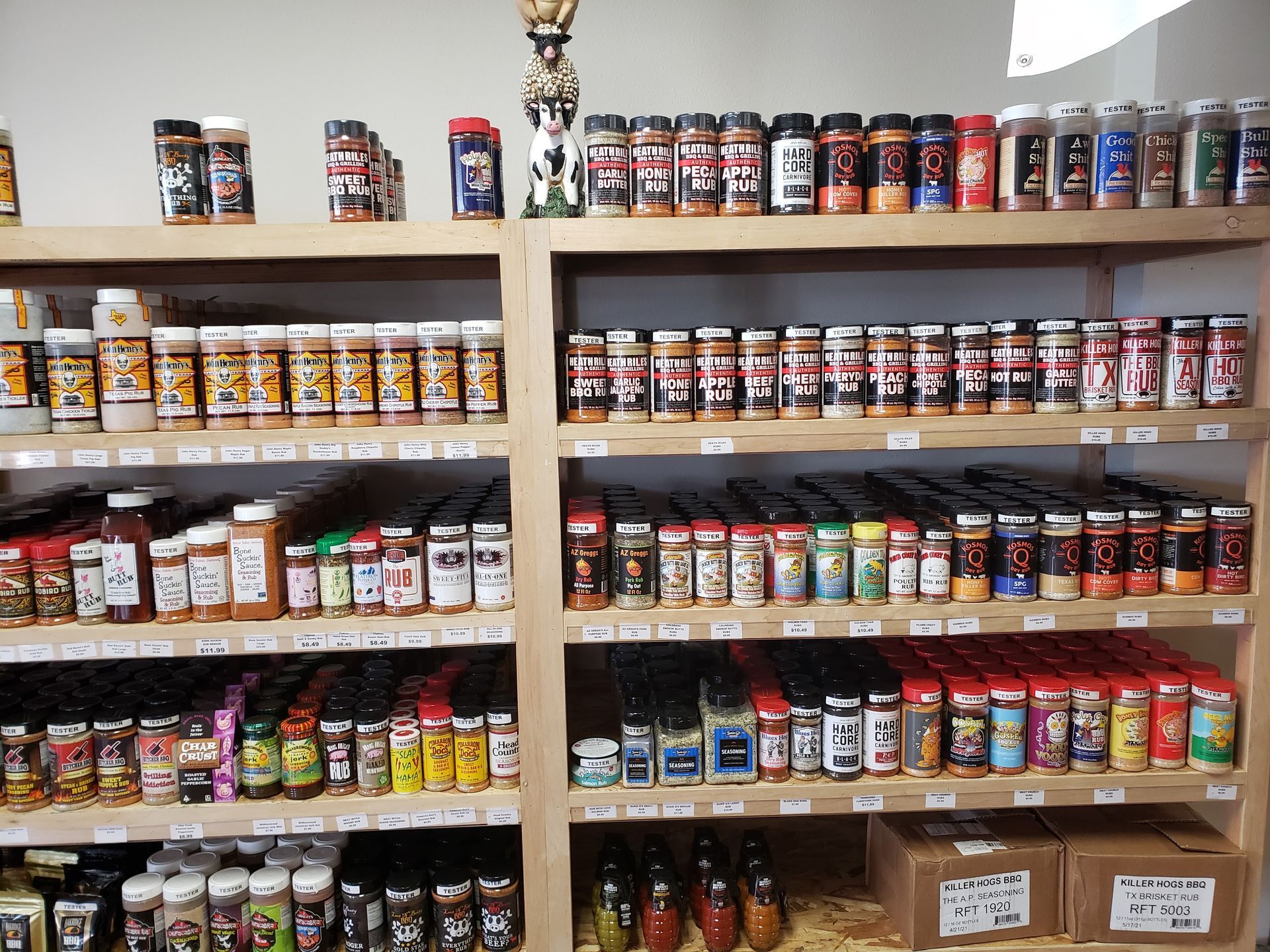 A store shelf filled with jars of spices and condiments