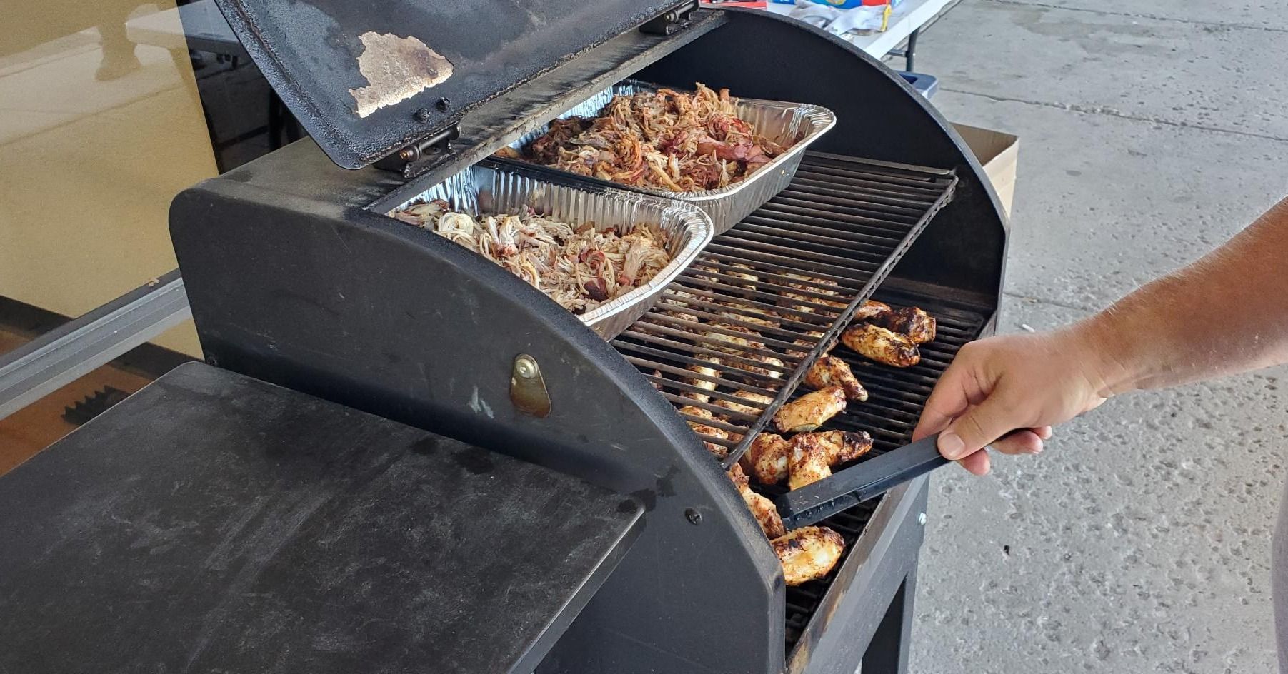 A person is cooking food on a grill.