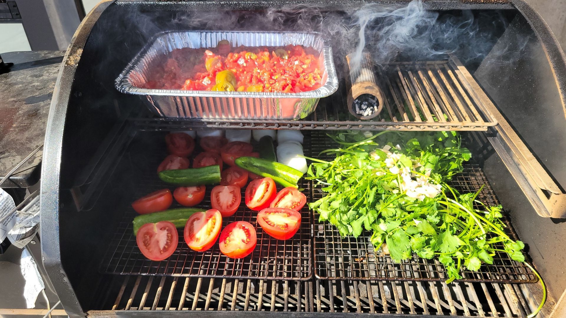 A grill filled with tomatoes and other vegetables