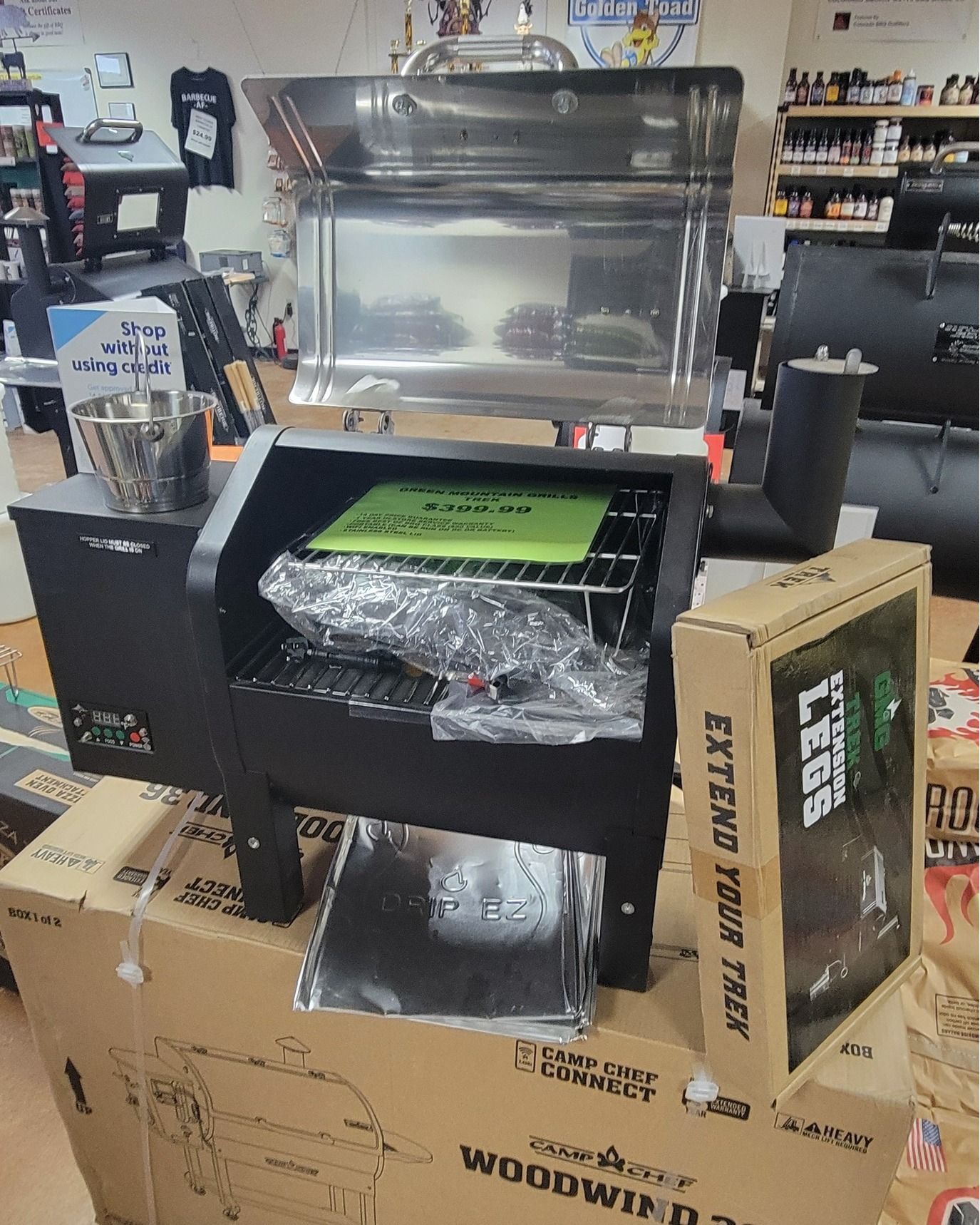 A woodwind grill is sitting on top of a pile of boxes