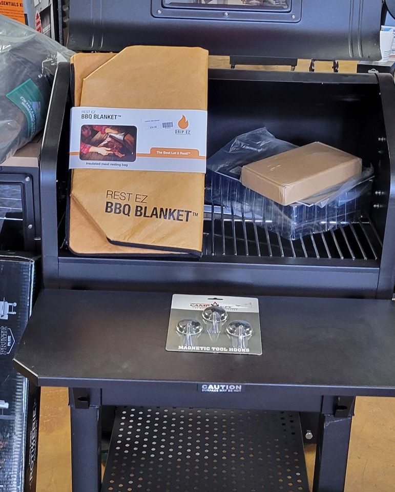 A bbq blanket is sitting on top of a grill