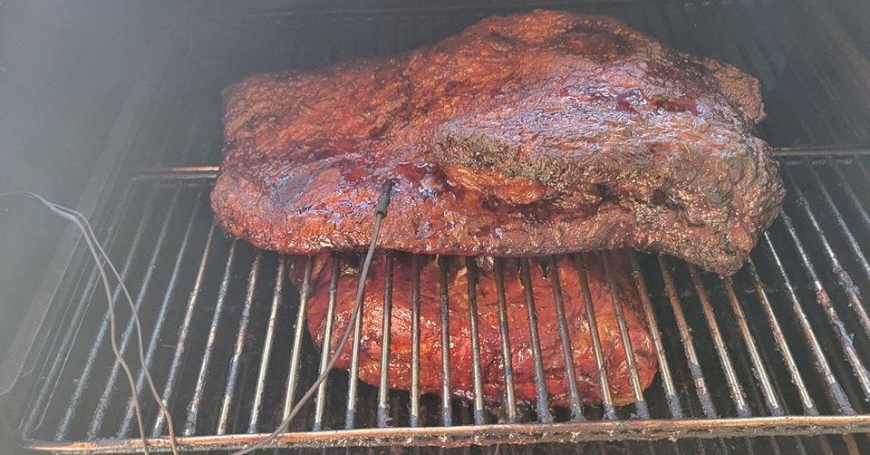 A large piece of meat is cooking on a grill.